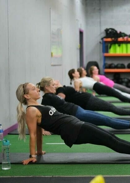 Personal trainer coaching ladies class.